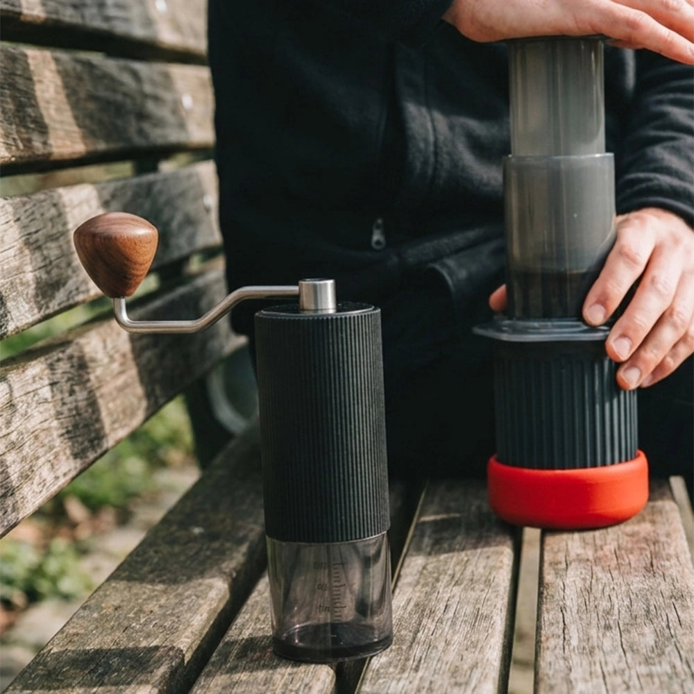 Lopder MAXA manual grinder used beside an AeroPress during an outdoor coffee ritual