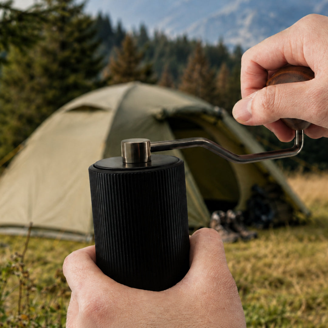 Lopder MAXA manual coffee grinder used at a campsite without electricity