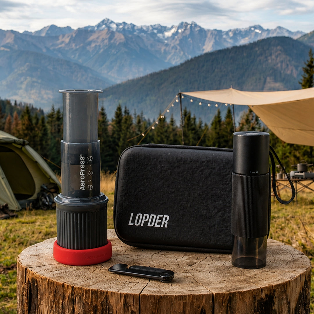 Lopder MAXA, travel case, and portable coffee gear arranged outdoors