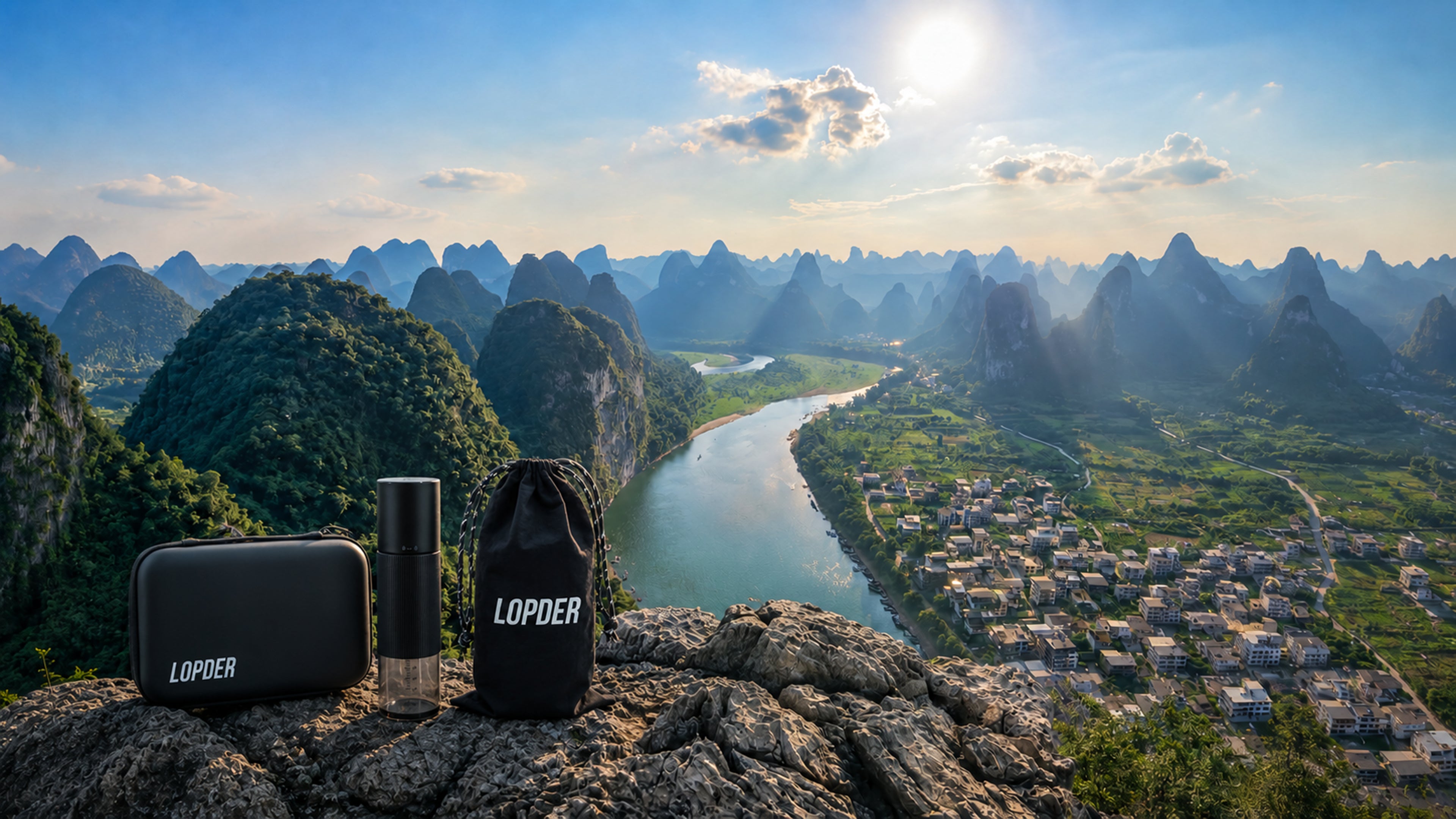 Lopder MAXA grinder, travel case, and storage bag overlooking a mountain landscape