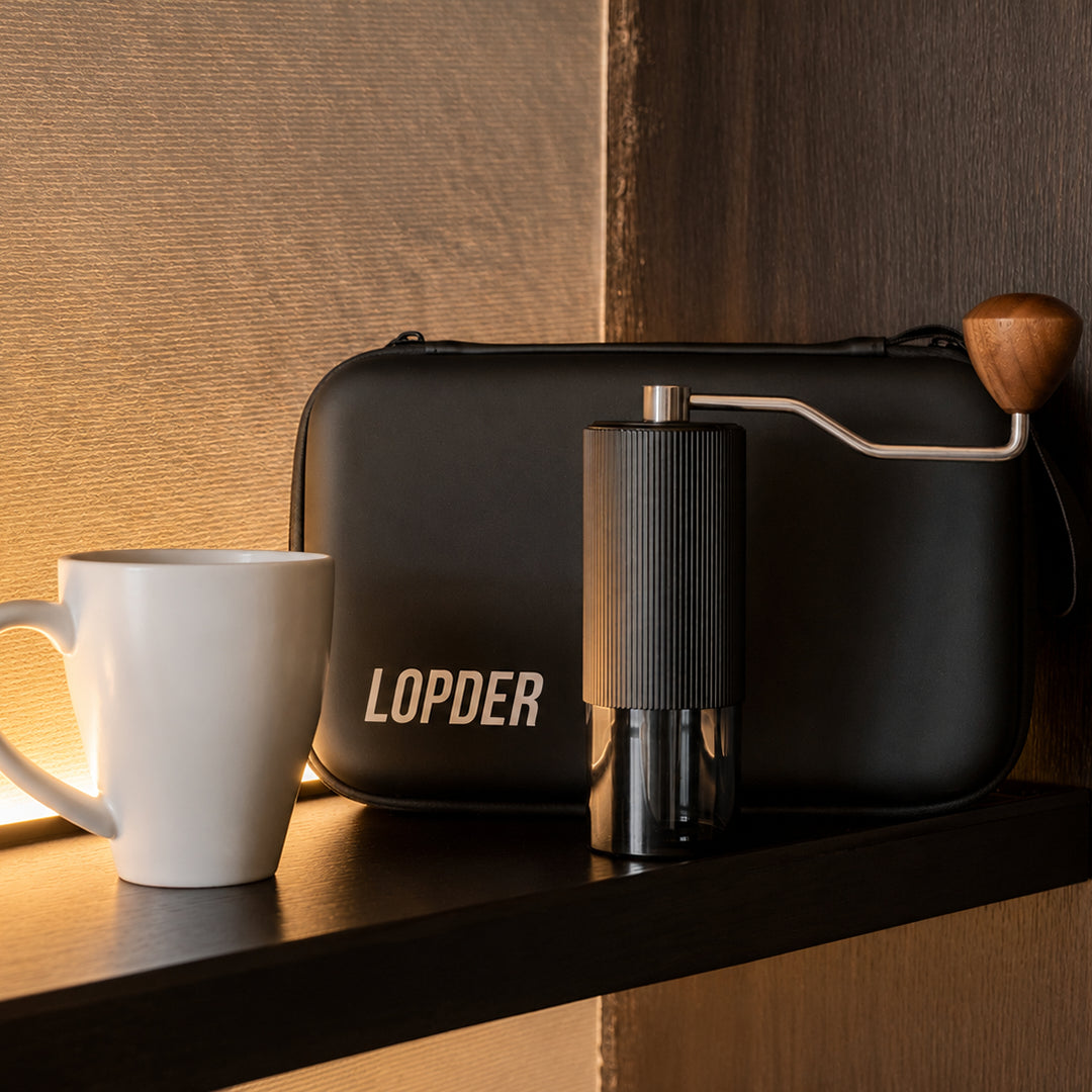Lopder MAXA manual grinder and travel case on a home coffee counter