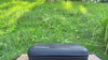 Lopder MAXA hybrid grinder beside its protective travel case outdoors